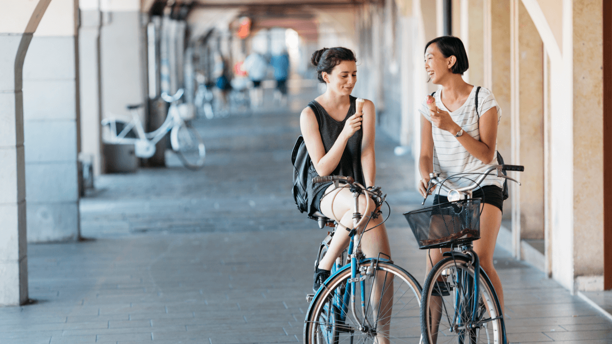 two women on bikes discussing the benefits of being bilingual
