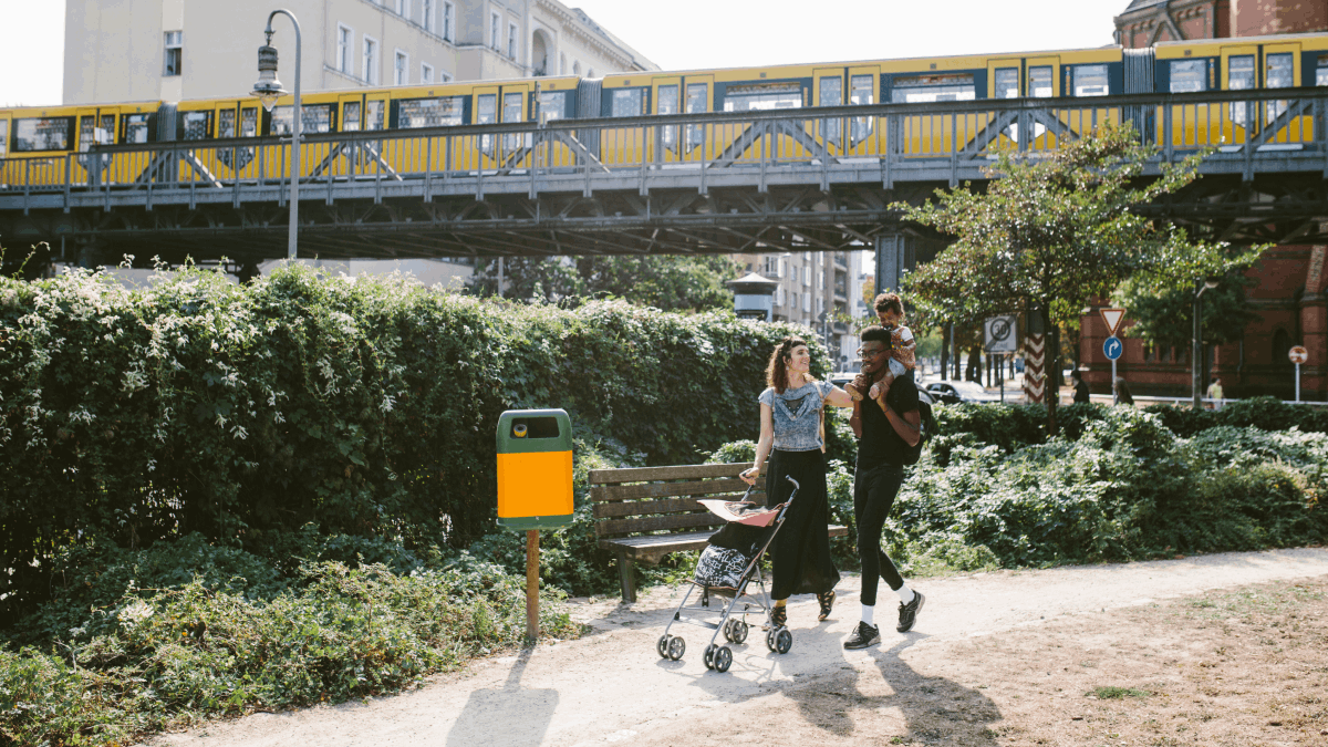 couple walking with stroller in front of train common german verbs