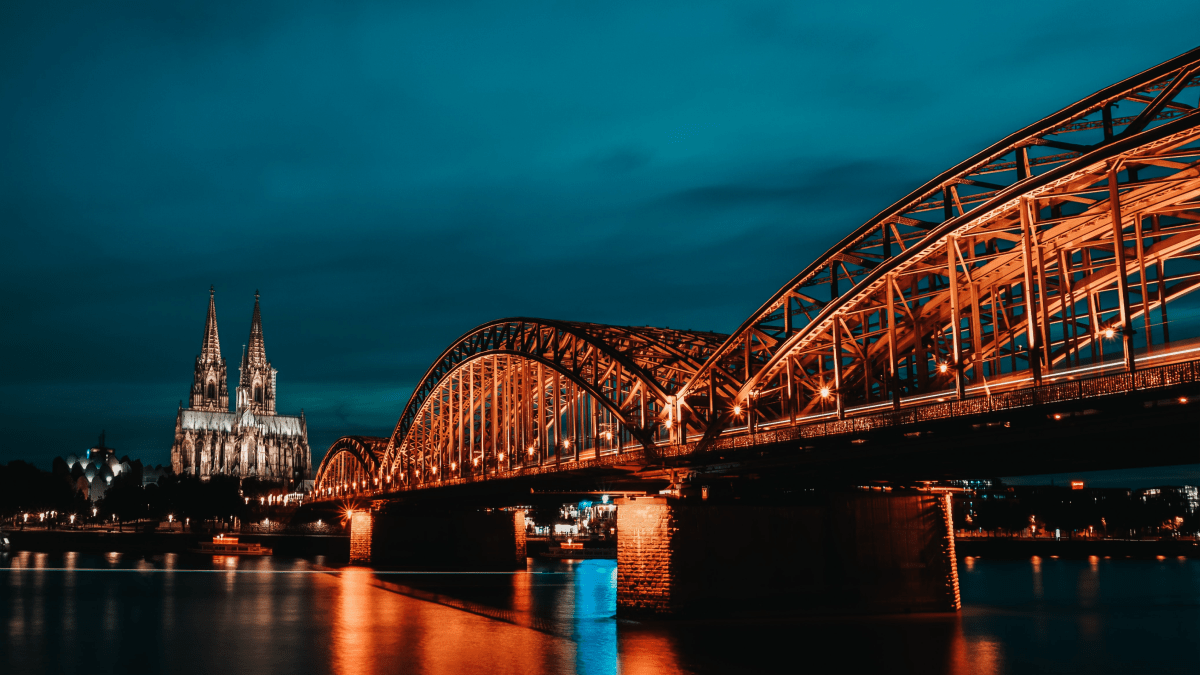 The Franconian dialect represented by a nighttime photo of a bridge in Cologne, Germany.