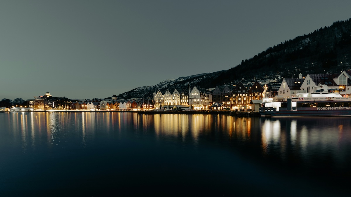 Scandi noir represented by a view of Bergen, Norway, from the water at night.